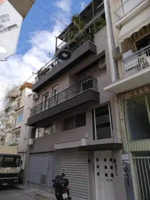 a motorcycle parked in front of a building at Gazi view apartments #1 in Athens