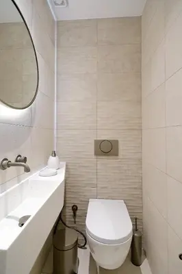 a bathroom with a toilet and a sink and a mirror at The Fancy Philosopher Apartment in Athens