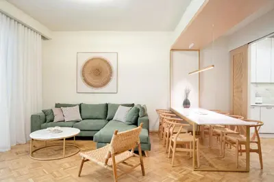 a living room with a green couch and a table at The Fancy Philosopher Apartment in Athens