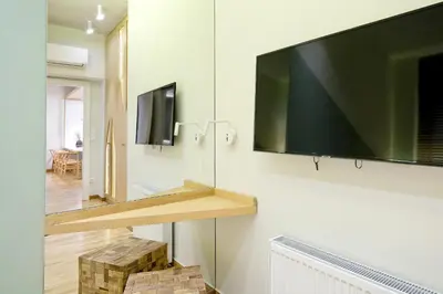 a large flat screen tv hanging on a wall at The Fancy Philosopher Apartment in Athens