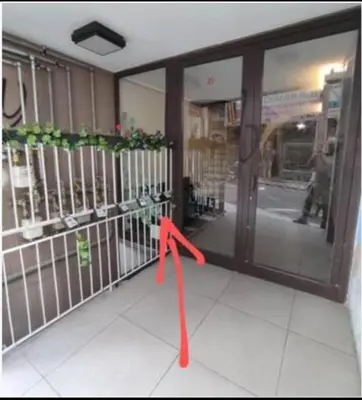 a red ribbon is standing in front of a store door at COZY Studio, Athens city center in Athens
