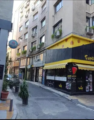 a street with a store on the side of a building at COZY Studio, Athens city center in Athens