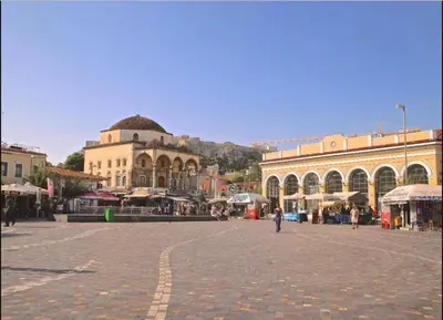 a person walking through a plaza in a city at COZY Studio, Athens city center in Athens