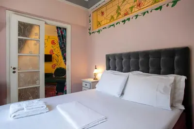 a bedroom with a large bed with white pillows at Eclectic 4-Bed, 4-Bath Apt in Central Athens - AK1 in Athens