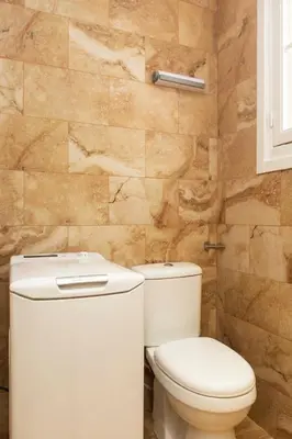 a bathroom with a toilet and a stone wall at Eclectic 4-Bed, 4-Bath Apt in Central Athens - AK1 in Athens