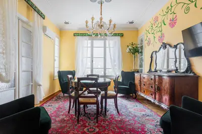 a dining room with a table and chairs and a chandelier at Eclectic 4-Bed, 4-Bath Apt in Central Athens - AK1 in Athens