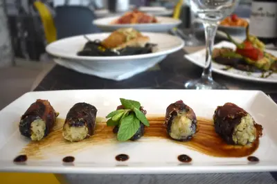 a plate of food on a table with plates of food at Athenian Montaza Hotel in Athens
