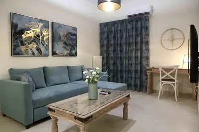 a living room with a blue couch and a coffee table at Best House, Anakreontos, Perivolaki, Nikaia, P... in Piraeus