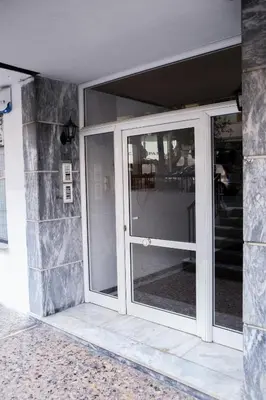 an entrance to a building with sliding glass doors at Best House, Anakreontos, Perivolaki, Nikaia, P... in Piraeus
