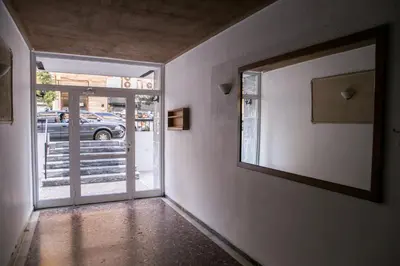 an empty hallway with a door to a parking lot at Best House, Anakreontos, Perivolaki, Nikaia, P... in Piraeus