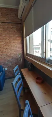 a table and two blue chairs in a room with a window at AS Athens Central Cozy Apartment 2 in Athens