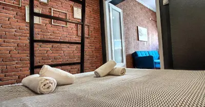 a bed in a room with a brick wall at AS Athens Central Cozy Apartment 2 in Athens