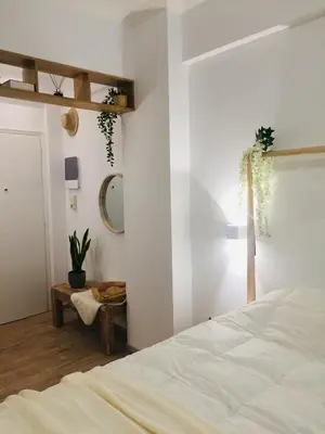 a bedroom with a white bed and a mirror at White Tundra Studio in Athens