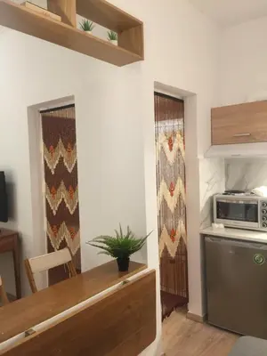 a kitchen with a table and a microwave on the wall at White Tundra Studio in Athens