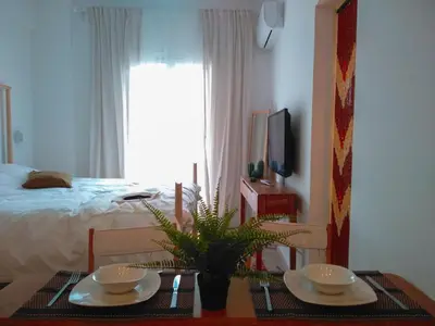 a bedroom with a bed and a table with two plates at White Tundra Studio in Athens