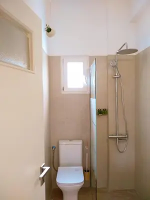 a bathroom with a toilet and a shower at White Tundra Studio in Athens