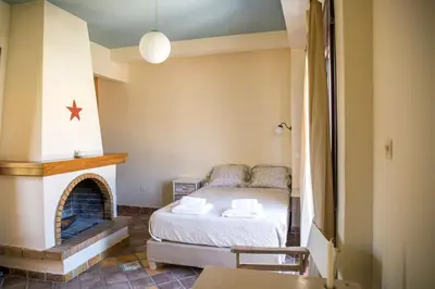 a small bedroom with a bed and a fireplace at Sunny Top Floor Studio - Excellent Athens view in Athens