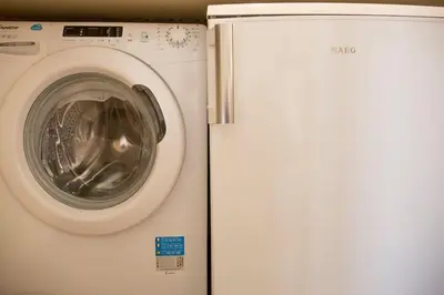 a white washing machine next to a refrigerator at Sunny Top Floor Studio - Excellent Athens view in Athens
