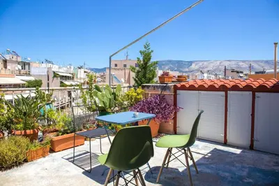 a patio with a table and chairs on a balcony at Sunny Top Floor Studio - Excellent Athens view in Athens