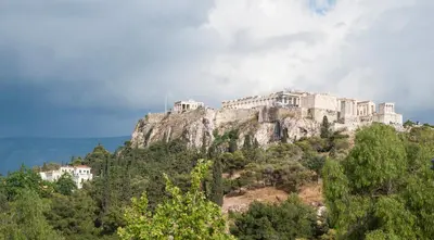 a castle on top of a mountain with trees at Hotel Thissio in Athens