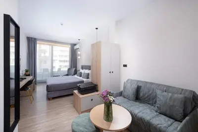 a living room with a couch and a table at Enattica Suites in Athens
