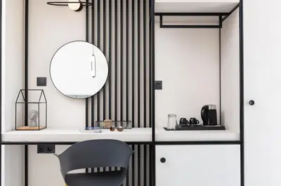 a black and white room with a chair and a mirror at Enattica Suites in Athens