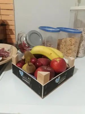 a box of fruit and nuts on a table at Helen's Welcoming & cozy flat in Koropíon
