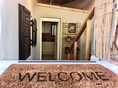 a welcome mat in theoyer of a house at Helen's Welcoming & cozy flat in Koropíon