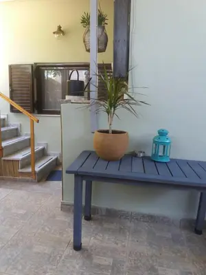 a blue bench with a potted plant on it at Helen's Welcoming & cozy flat in Koropíon