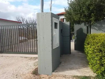 a white post with a window on the side of a fence at Helen's Welcoming & cozy flat in Koropíon