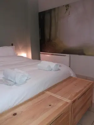 a bedroom with a bed with two towels on it at Helen's Welcoming & cozy flat in Koropíon