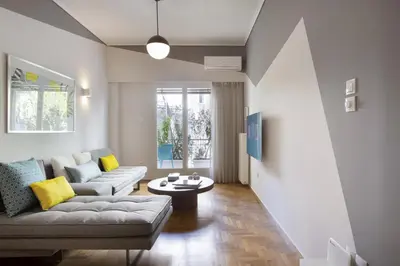 a living room with a couch and a table at Little gem 2 mins from Acropolis Museum in Athens
