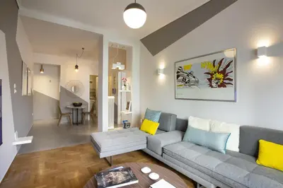 a living room with a couch and a table at Little gem 2 mins from Acropolis Museum in Athens