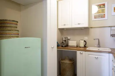 a kitchen with a white refrigerator and a sink at Little gem 2 mins from Acropolis Museum in Athens