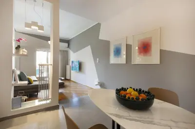 a dining room with a bowl of fruit on a table at Little gem 2 mins from Acropolis Museum in Athens
