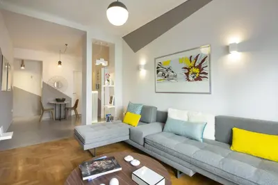 a living room with a couch and a table at Little gem 2 mins from Acropolis Museum in Athens