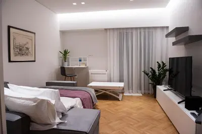 a hotel room with a bed and a television at Katia Modern Apartment in Athens in Athens