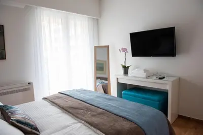 a bedroom with a bed and a tv on the wall at Katia Modern Apartment in Athens in Athens