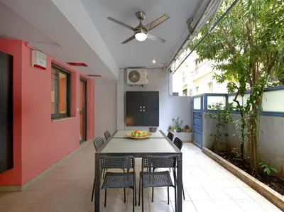 a dining room with a table and chairs at Koukaki garden escape child friendly apartment in Athens