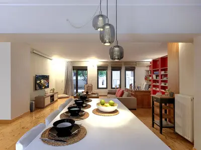 a living room with a table with bowls of fruit on it at Koukaki garden escape child friendly apartment in Athens