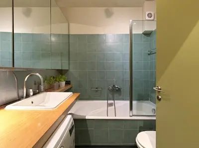a bathroom with a tub and a sink and a toilet at Koukaki garden escape child friendly apartment in Athens