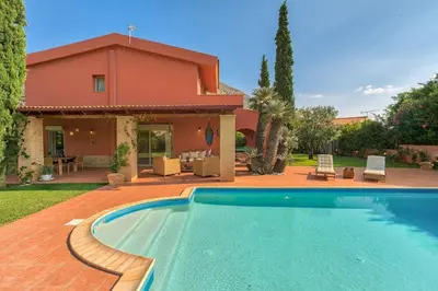 a house with a swimming pool in front of a house at Villa Casa Del Sol with private pool in Sounio