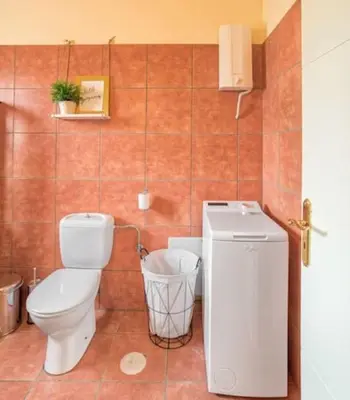 a bathroom with a toilet and a sink at Villa Casa Del Sol with private pool in Sounio