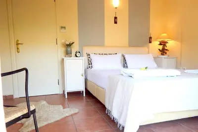 a bedroom with two beds and a table at Villa Casa Del Sol with private pool in Sounio