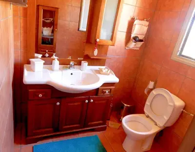 a bathroom with a sink and a toilet at Villa Casa Del Sol with private pool in Sounio