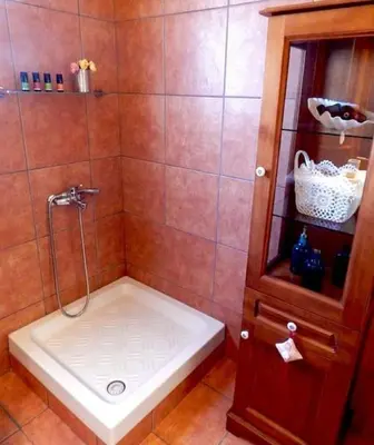 a bathroom with a shower with a sink and a cabinet at Villa Casa Del Sol with private pool in Sounio