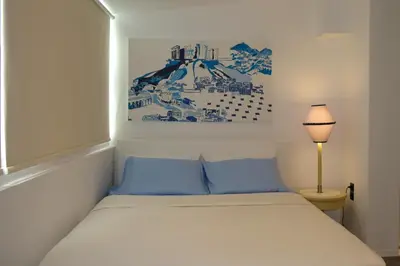 a bedroom with a bed and a picture on the wall at STUDIO ANASTASIA in Athens
