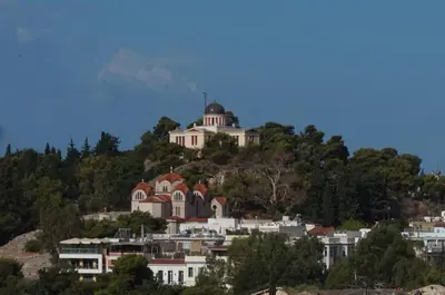 a building on top of a hill with houses at STUDIO ANASTASIA in Athens