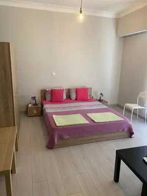 a bedroom with a large bed with pink pillows at Aris Apartment in Athens