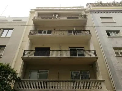 an apartment building with balconies on the side of it at Aris Apartment in Athens
